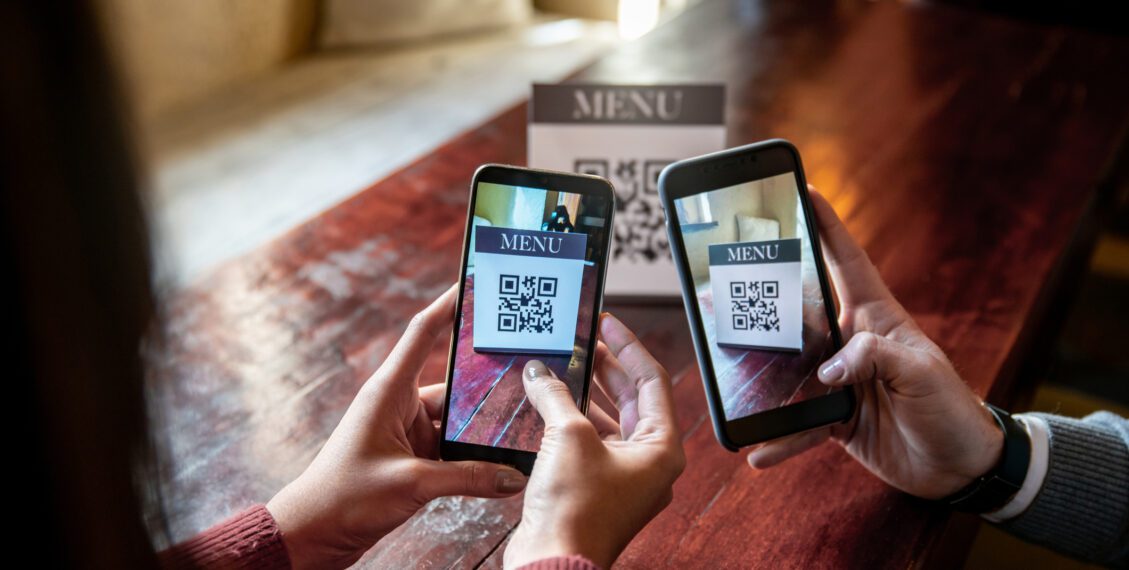 a couple phones scanning a qr code 