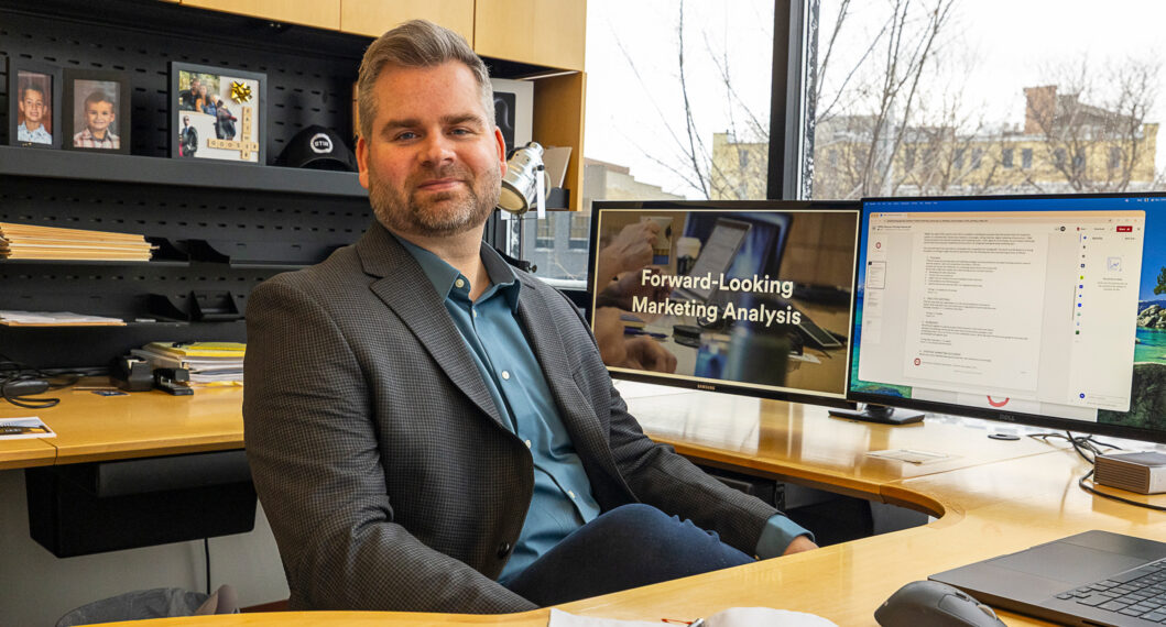 rick stoner, new president and owner, sitting at his desk